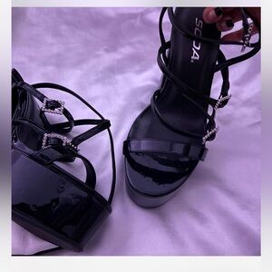 black platform heels with silver buckles